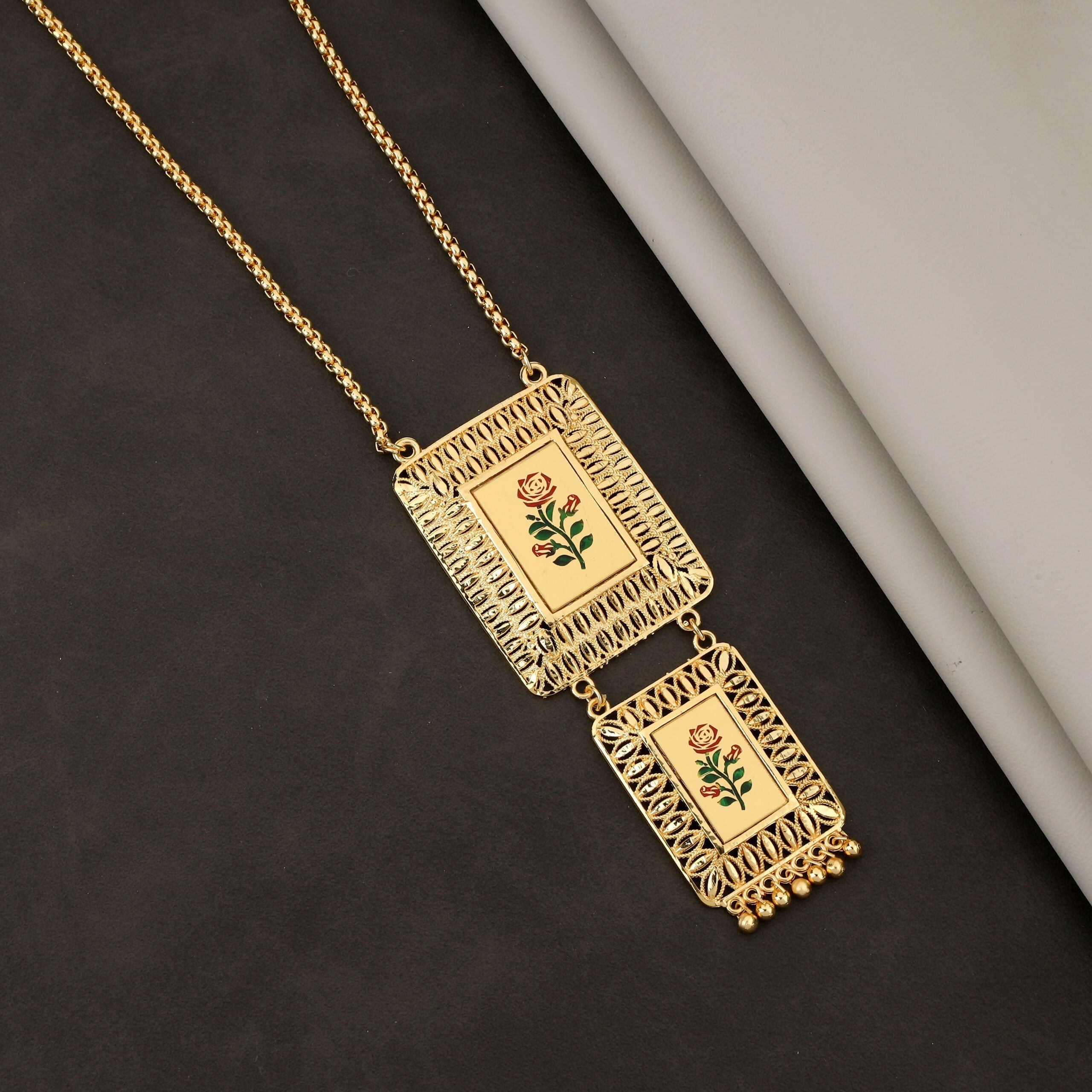 Enhance your jewelry collection with this exquisite Gold-Plated Long Chain Necklace, designed to reflect timeless Indian artistry with a modern touch. Featuring a unique double-pendant design, this necklace beautifully blends traditional elegance with con