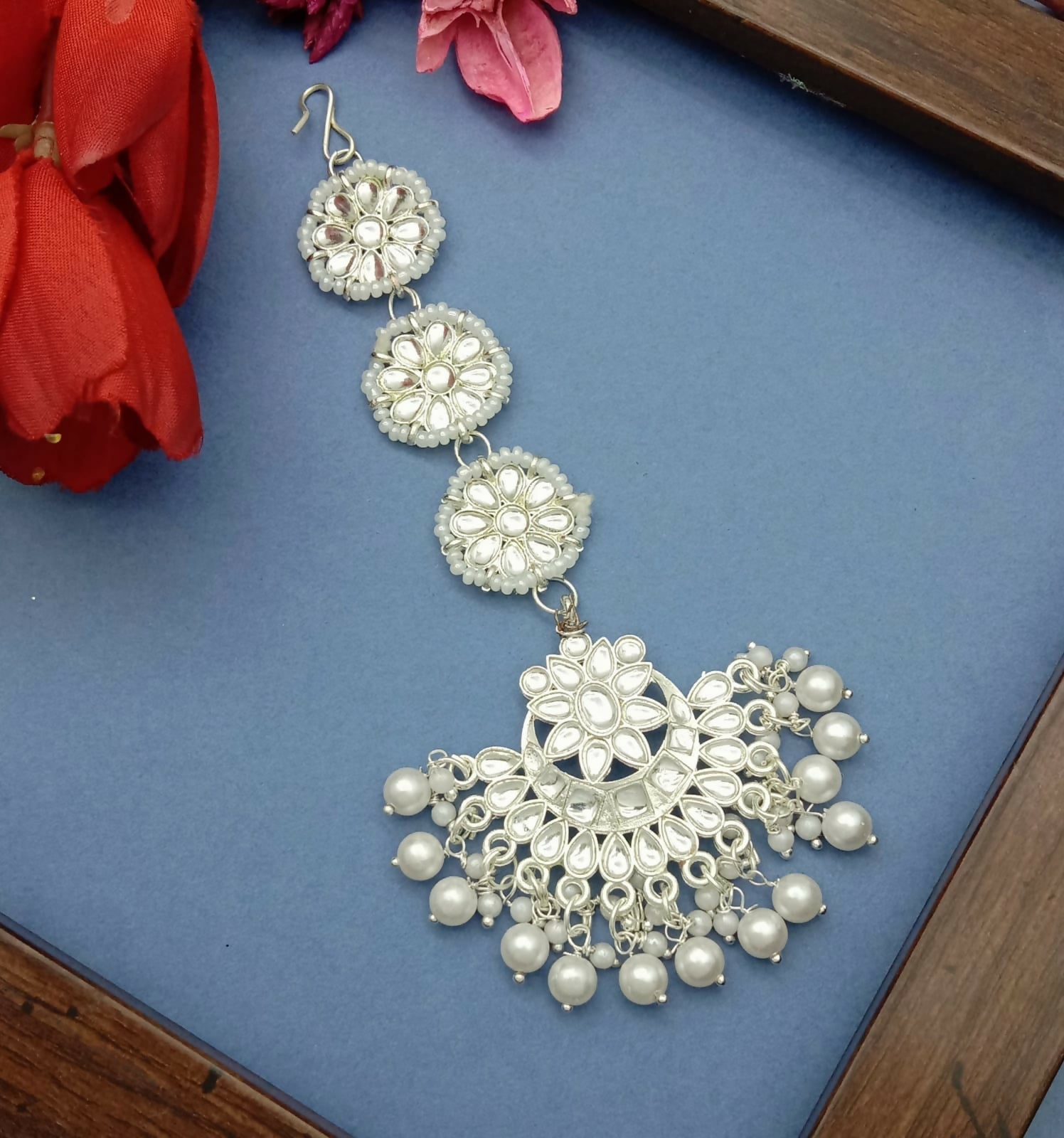 Enhance your ethnic look with this elegant White Gold Plated Kundan Maang Tika, designed to add timeless charm and grace to your traditional attire. Crafted with precision, this beautiful piece features sparkling artificial stones and delicate bead detail